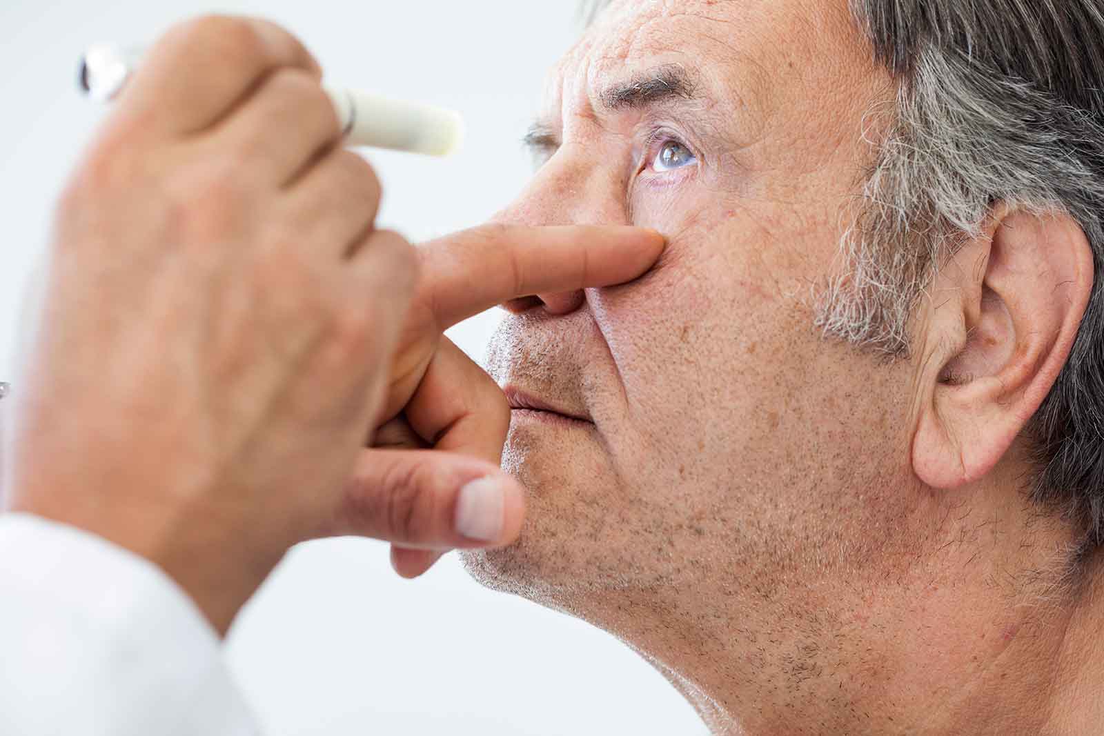 A man is taking an eye test with a doctor.